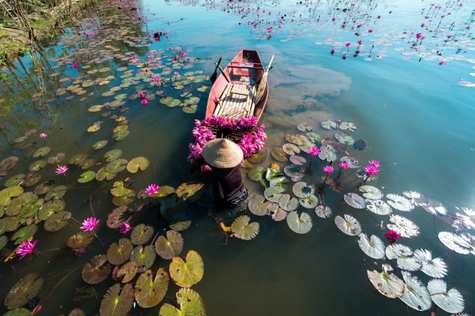 We embark on a boat trip to the Trang An Landscape Complex