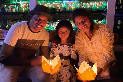Tourists release lanterns in Hoi An to pray for good luck, illuminating the Hoai River.