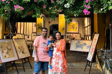 Tourists enjoy the beautiful paintings at a cafe in Hoi An.